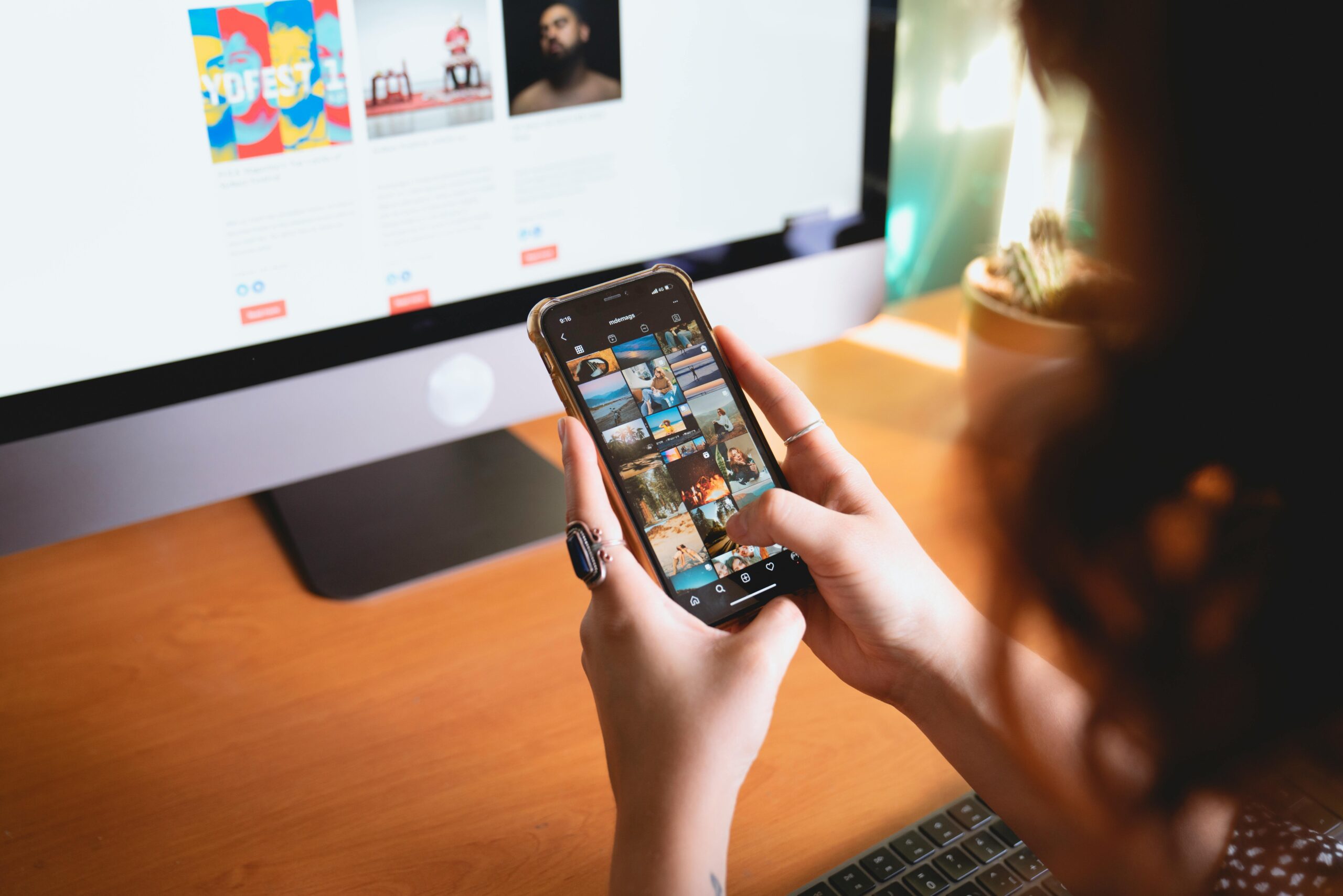 A person's hand holding a smartphone displaying social media and communication apps.